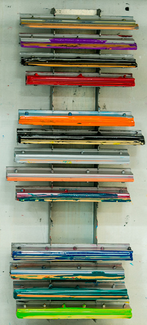 Here you see a row with squeegees. We use them when we make direct printing